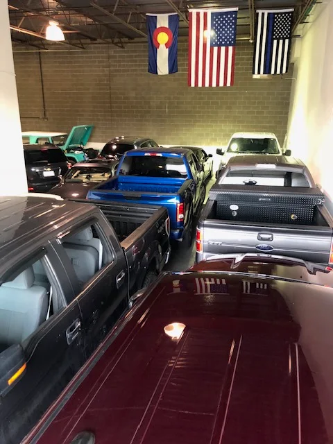 Trucks lined up inside the shop waiting for hail repair