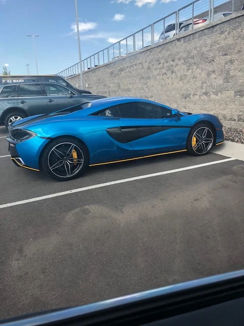 Blue McLaren 570S parked outside after repair