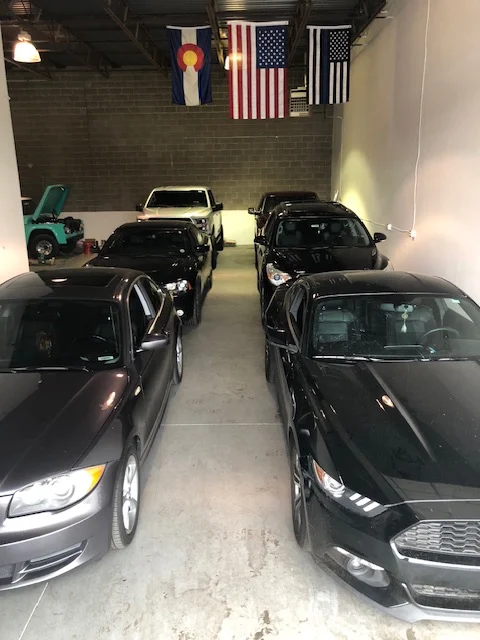 Row of cars lined up inside the Summit Hail Repair shop